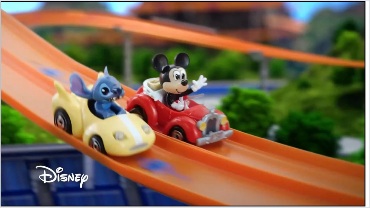 Disney character vehicles racing on orange Hot Wheels track, excerpted from Mattel's March 2024 investor deck.
